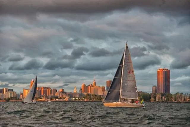 Slide: The Image of Sailboats on water with city skyline, featuring a 1990 Tartan Thomas 35. - 1