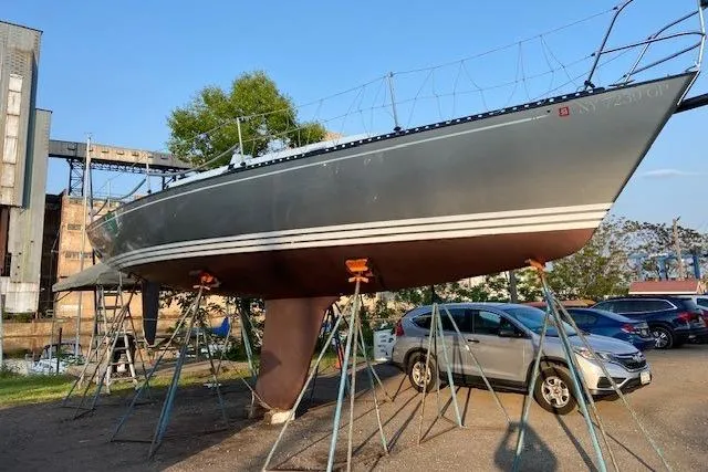 Slide: The Image of 1990 Tartan Thomas 35 sailboat on stands in a parking lot. - 10