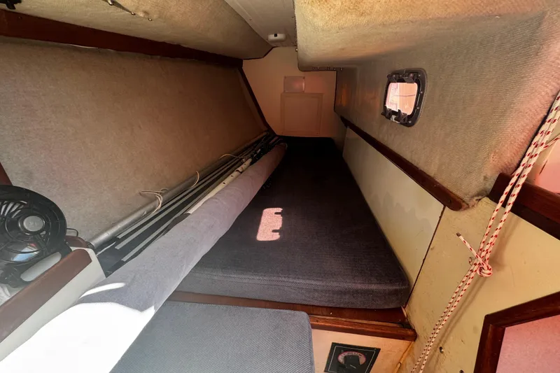 Slide: The Image of Cozy cabin interior of 1990 Tartan Thomas 35 sailboat with window and fan. - 14