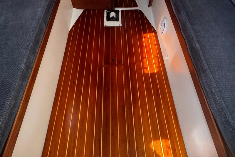 Slide: The Image of Interior of 1990 Tartan Thomas 35 sailboat with polished wooden flooring. - 17