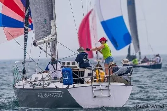 Slide: The Image of Sailboat "Polar Express" racing, Tartan Thomas 35, 1990, with colorful spinnakers in background. - 2