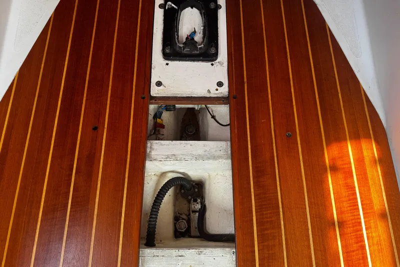 Slide: The Image of Wooden deck interior of 1990 Tartan Thomas 35 sailboat, showing maintenance access panel. - 20
