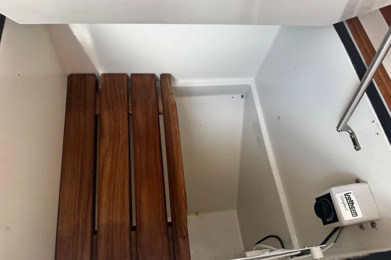 Slide: The Image of Wooden slatted seat and equipment in a 1990 Tartan Thomas 35 boat interior. - 26