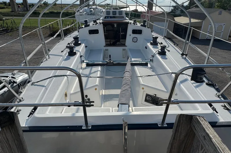 Slide: The Image of 1990 Tartan Thomas 35 sailboat cockpit with winches and seating, docked outdoors. - 34