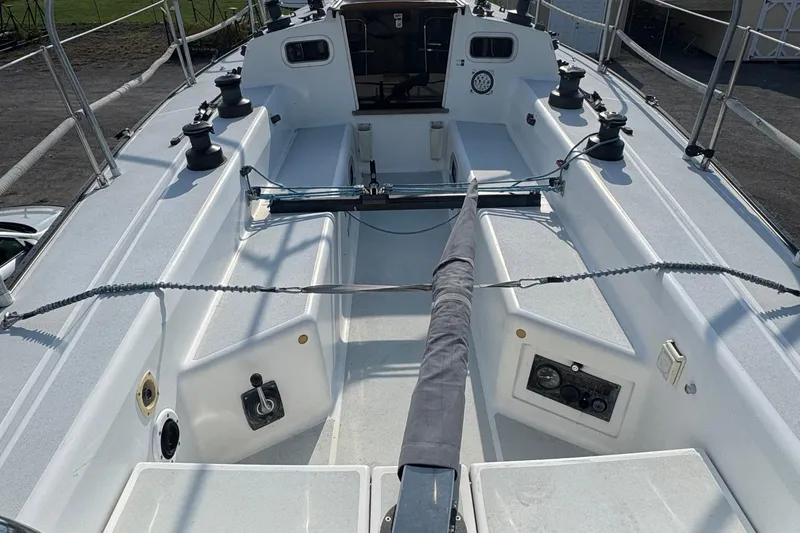 Slide: The Image of Cockpit view of a 1990 Tartan Thomas 35 sailboat, showcasing winches and seating. - 35