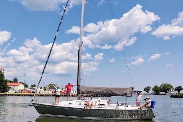 Slide: The Image of Sailboat Tartan Thomas 35, 1990 model, cruising on a sunny day with passengers onboard. - 4