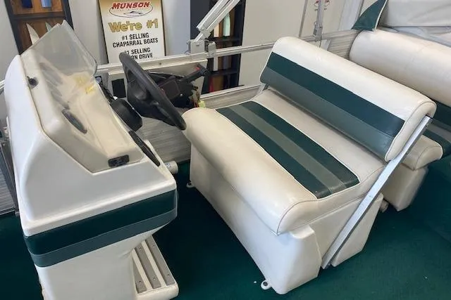 Slide: The Image of 2001 Odyssey Pontoons 1703 Millennium boat interior with white and green seating and steering console. - 12