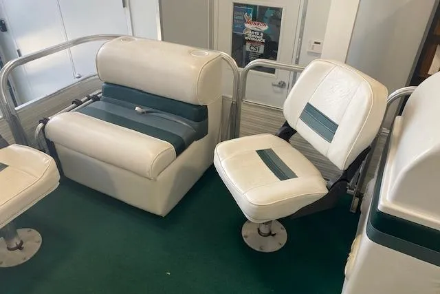 Slide: The Image of 2001 Odyssey Pontoons 1703 Millennium boat seats with green and white upholstery. - 14