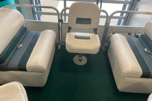 Slide: The Image of Interior seating of 2001 Odyssey Pontoons 1703 Millennium boat with green carpet. - 16