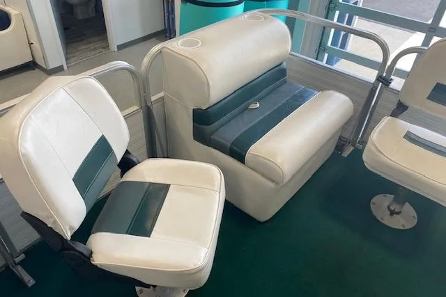 Slide: The Image of 2001 Odyssey Pontoons 1703 Millennium boat seats with white and green upholstery. - 17