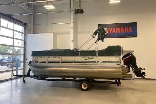 Slide: The Image of 2001 Odyssey Pontoons 1703 Millennium boat in a garage with Yamaha sign. - 2