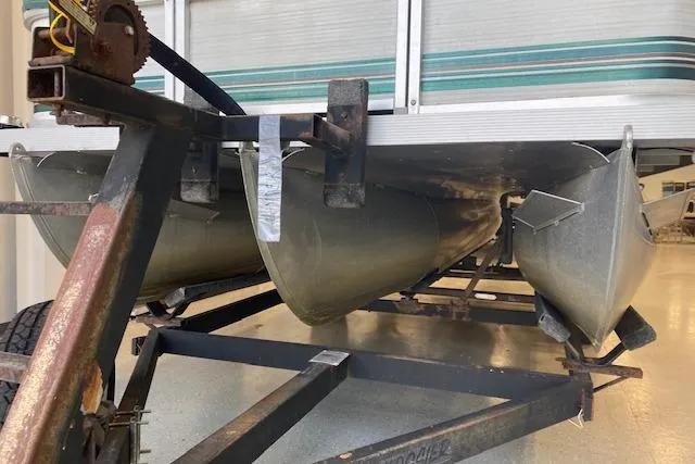 Slide: The Image of 2001 Odyssey Pontoons 1703 Millennium on trailer, showcasing pontoons and undercarriage. - 5