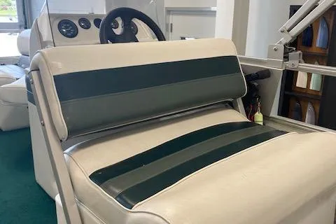 Slide: The Image of 2001 Odyssey Pontoons 1703 Millennium boat interior with striped seating and steering wheel. - 8