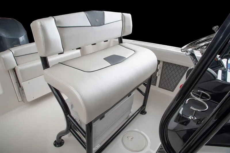 Slide: The Image of Manufacturer Provided Image: 2017 Wellcraft 222 Fisherman boat interior with cushioned seating and steering console. - 10