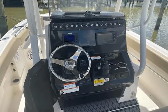 Slide: The Image of 2017 Wellcraft 222 Fisherman boat console with steering wheel and navigation controls. - 4