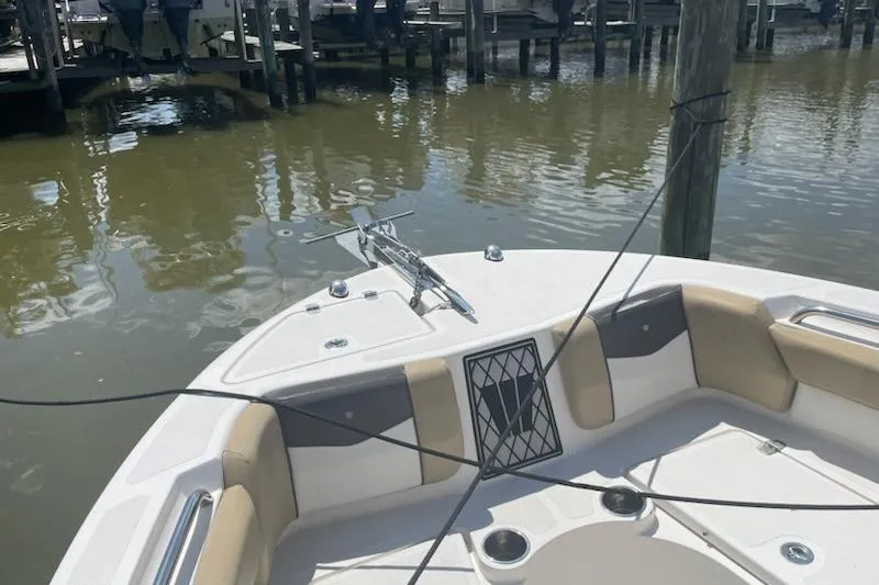 Slide: The Image of 2017 Wellcraft 222 Fisherman boat docked, featuring bow seating and anchor. - 6