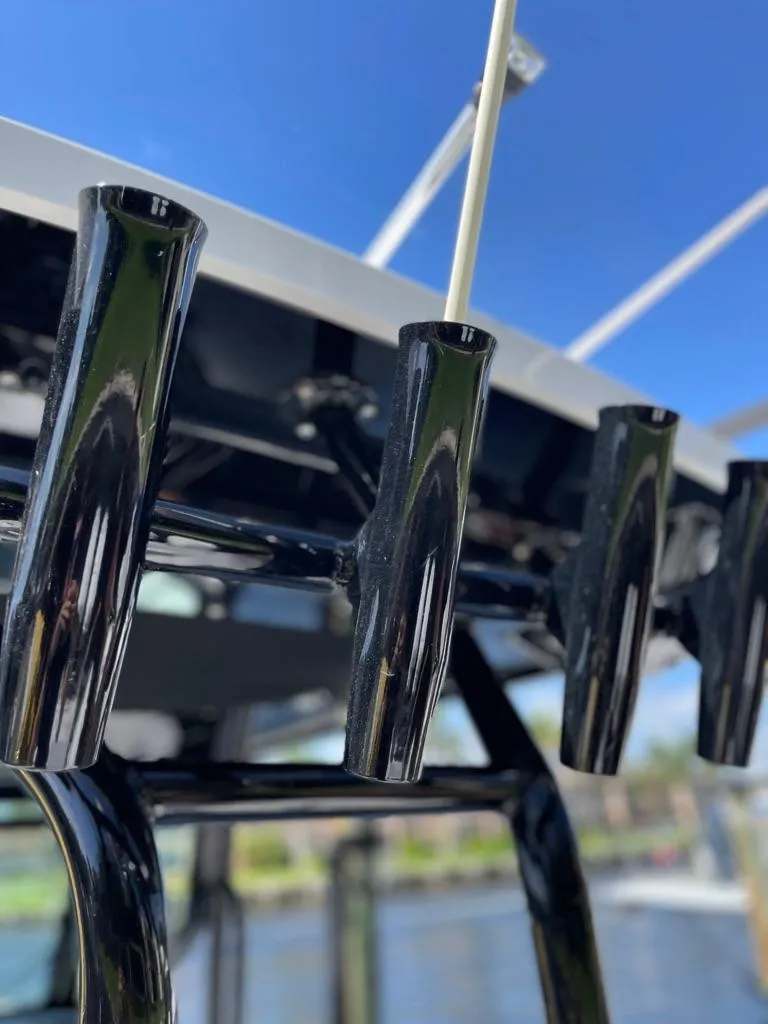 Slide: The Image of 2019 Blackfin 272 CC boat rod holders against a clear blue sky. - 11