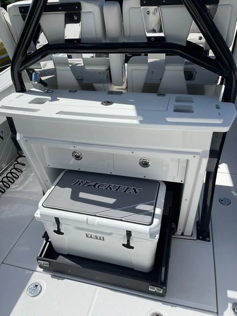 Slide: The Image of 2019 Blackfin 272 CC boat interior with Yeti cooler and storage drawers. - 12