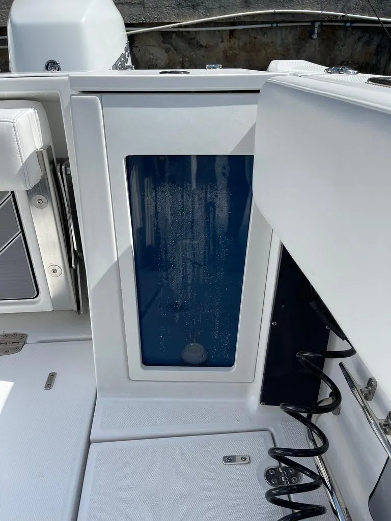 Slide: The Image of 2019 Blackfin 272 CC boat interior with open storage compartment. - 15