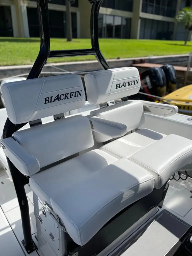 Slide: The Image of 2019 Blackfin 272 CC boat with white cushioned seating and branded backrests. - 16