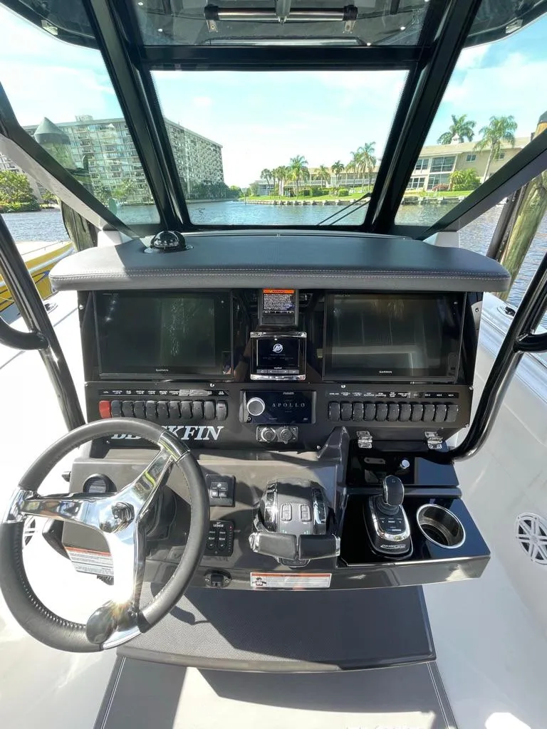 Slide: The Image of 2019 Blackfin 272 CC boat dashboard with steering wheel and navigation controls. - 18
