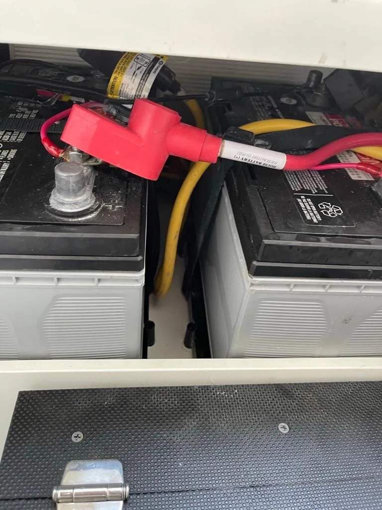 Slide: The Image of 2019 Blackfin 272 CC boat batteries with red and yellow cables connected. - 34