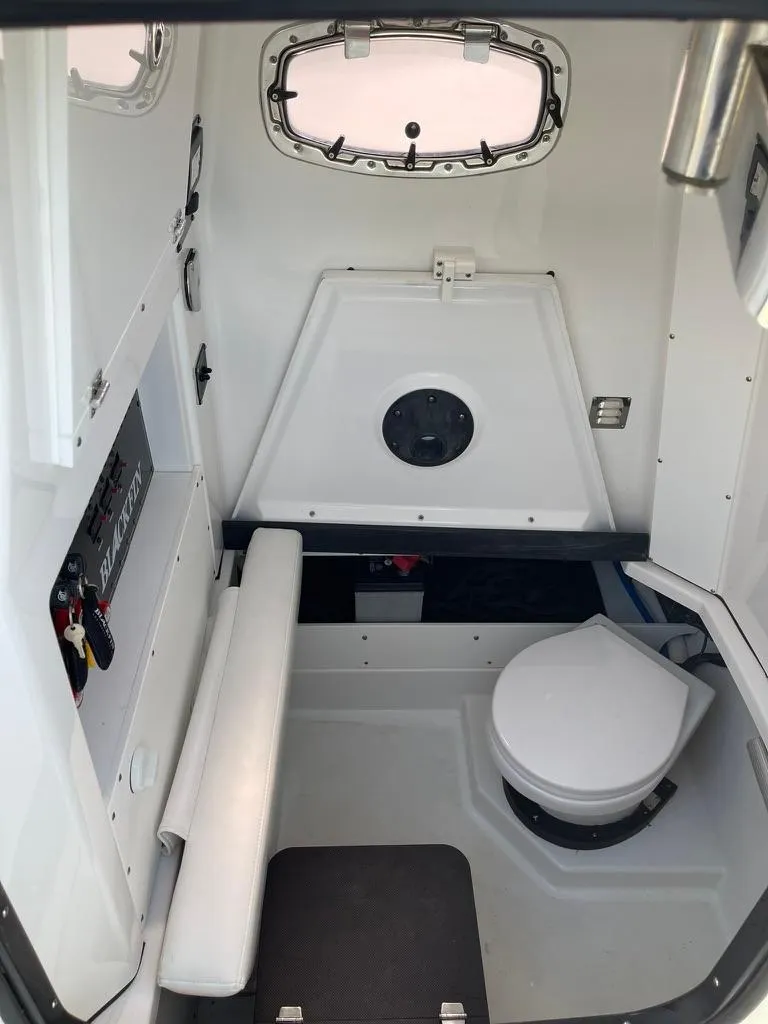 Slide: The Image of 2019 Blackfin 272 CC cabin interior with seating and marine toilet. - 35
