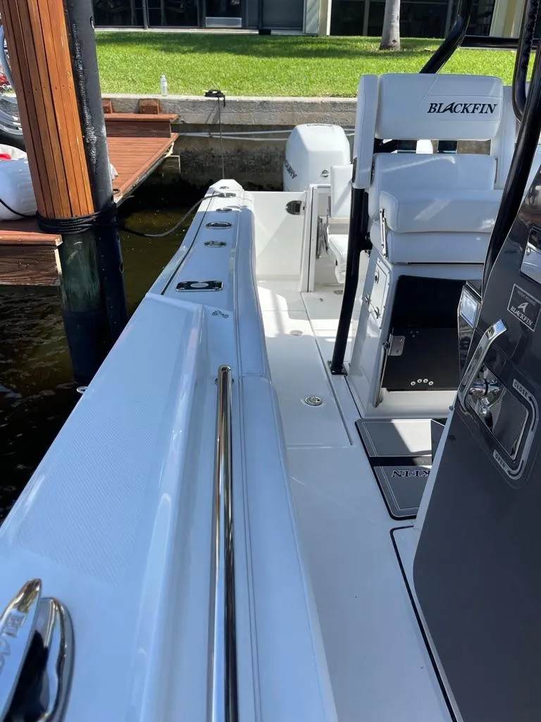 Slide: The Image of 2019 Blackfin 272 CC boat docked, showcasing sleek design and modern features. - 46