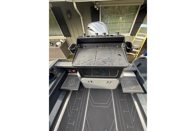 Slide: The Image of 2024 Stabicraft 2050 Supercab boat interior with storage compartments and sleek design. - 10