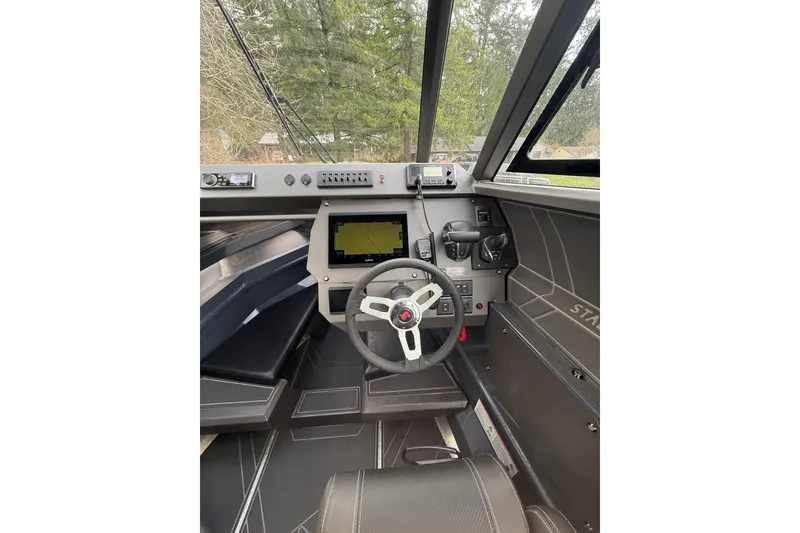 Slide: The Image of 2024 Stabicraft 2050 Supercab interior with steering wheel and navigation system. - 13