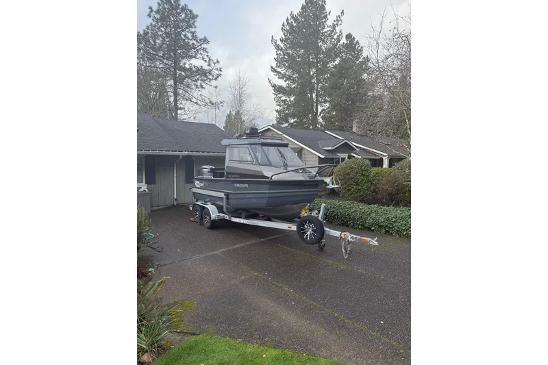 Slide: The Image of 2024 Stabicraft 2050 Supercab boat on trailer in residential driveway. - 2