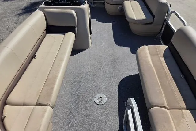 Slide: The Image of 2017 Sun Tracker Party Barge 20 DLX interior with beige seating and spacious layout. - 5