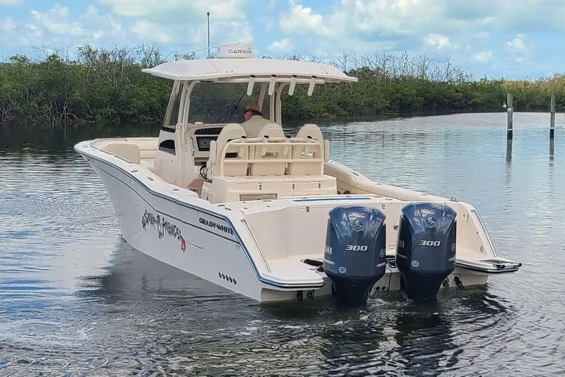 Slide: The Image of 2020 Grady-White Canyon 326 boat with twin Yamaha 300 engines on calm water. - 1