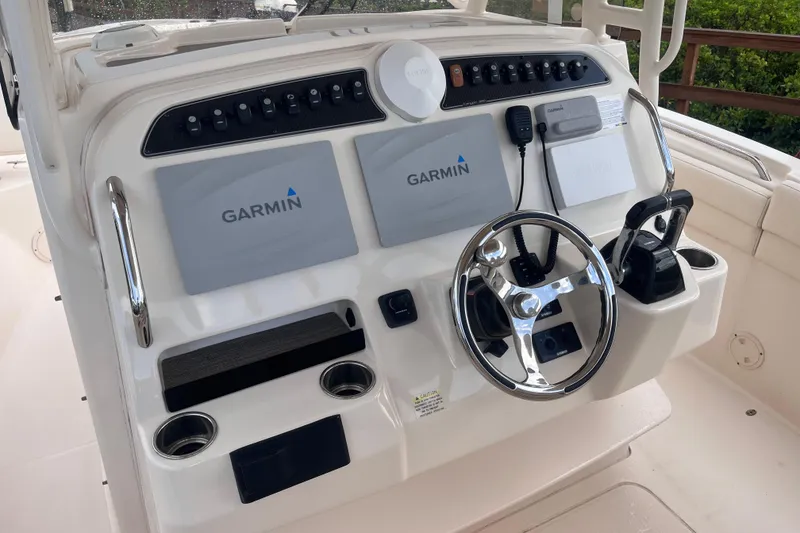 Slide: The Image of 2020 Grady-White Canyon 326 helm with Garmin displays and steering wheel. - 15