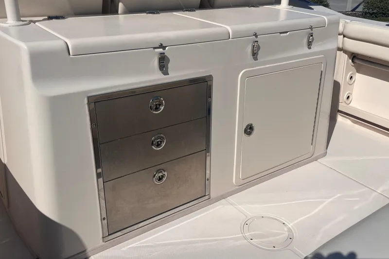 Slide: The Image of 2020 Grady-White Canyon 326 boat interior with storage compartments and drawers. - 16