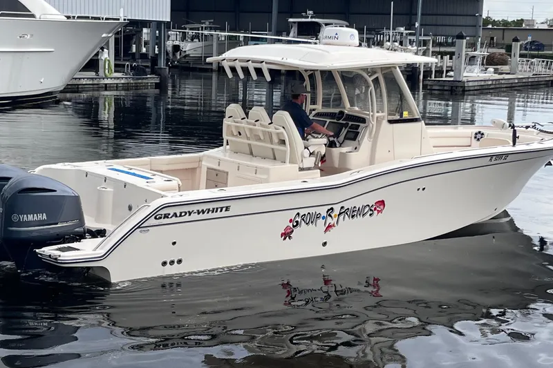 Slide: The Image of 2020 Grady-White Canyon 326 boat with Yamaha engines docked at marina. - 2
