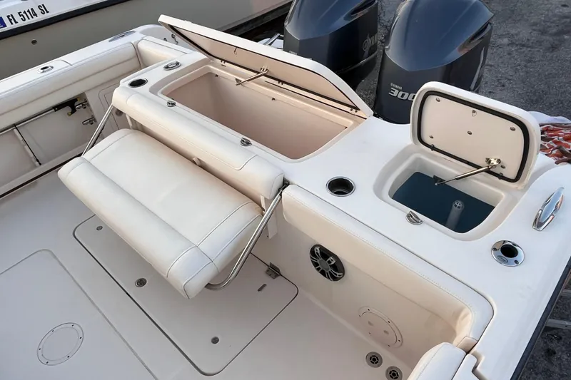 Slide: The Image of 2020 Grady-White Canyon 326 boat interior with seating, storage, and dual Yamaha engines. - 21