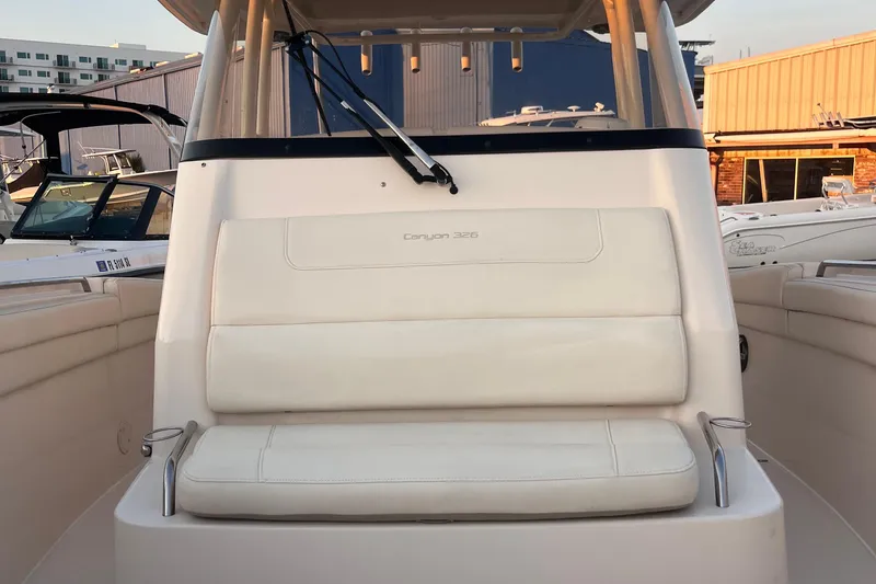 Slide: The Image of 2020 Grady-White Canyon 326 boat interior with cushioned seating and cup holders. - 32