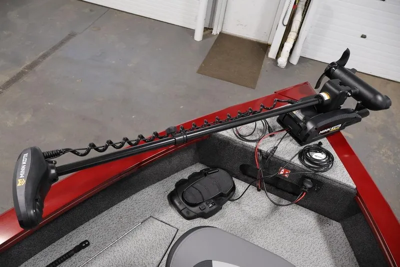 Slide: The Image of 2026 Lowe Fishing Machine 1875 with Minn Kota trolling motor in a garage setting. - 11