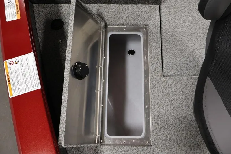 Slide: The Image of 2026 Lowe Fishing Machine 1875 boat storage compartment with open lid and warning labels. - 14