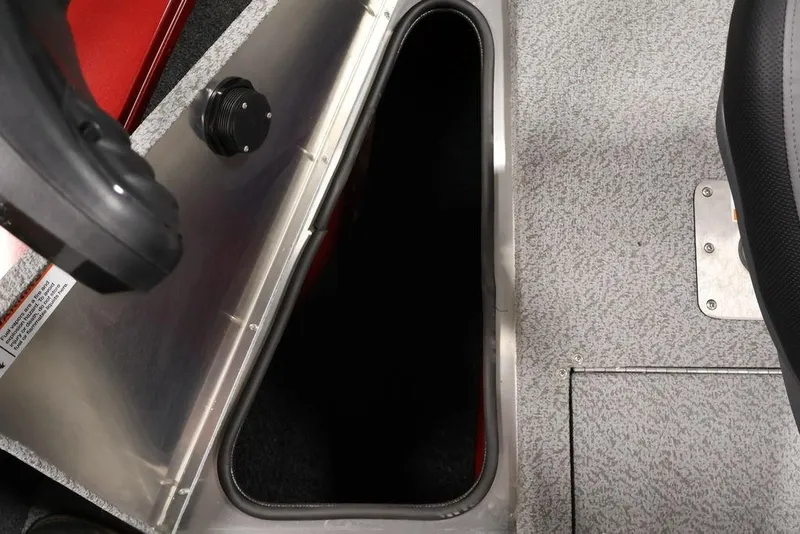 Slide: The Image of 2026 Lowe Fishing Machine 1875 boat storage compartment with open hatch and textured flooring. - 20