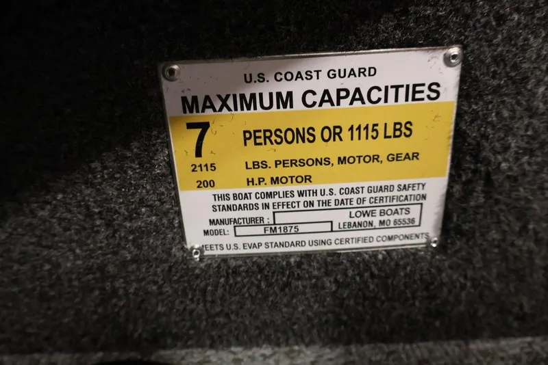 Slide: The Image of U.S. Coast Guard capacity label for Lowe Fishing Machine 1875, 2026 model, 7 persons or 1115 lbs. - 22