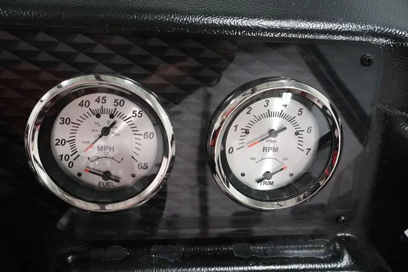 Slide: The Image of Dashboard gauges of 2026 Lowe Fishing Machine 1875, showing speed and RPM. - 23