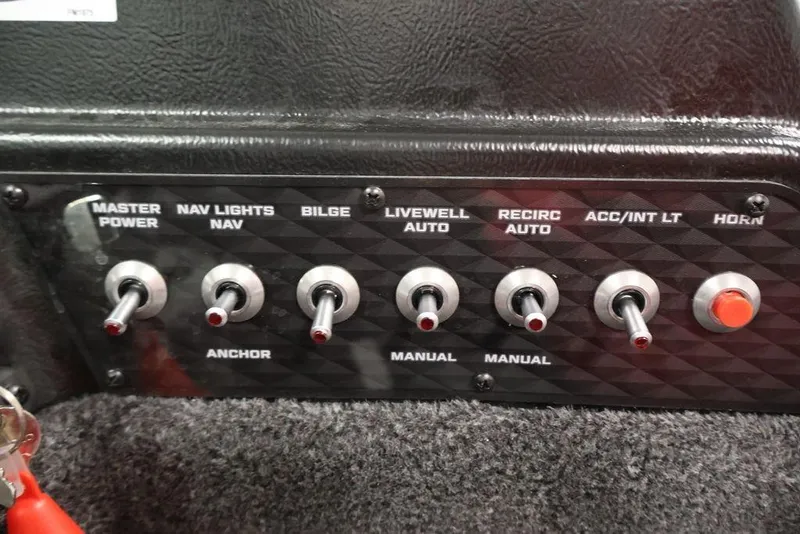 Slide: The Image of Control panel of 2026 Lowe Fishing Machine 1875 with various toggle switches. - 24