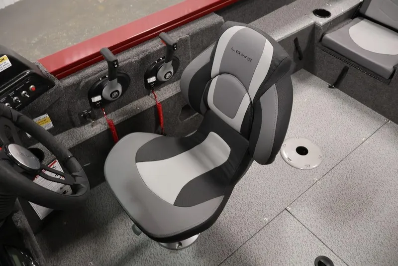 Slide: The Image of 2026 Lowe Fishing Machine 1875 interior with steering wheel and comfortable seating. - 28
