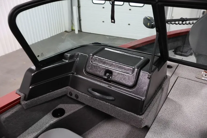 Slide: The Image of 2026 Lowe Fishing Machine 1875 boat interior with windshield and storage compartment. - 29