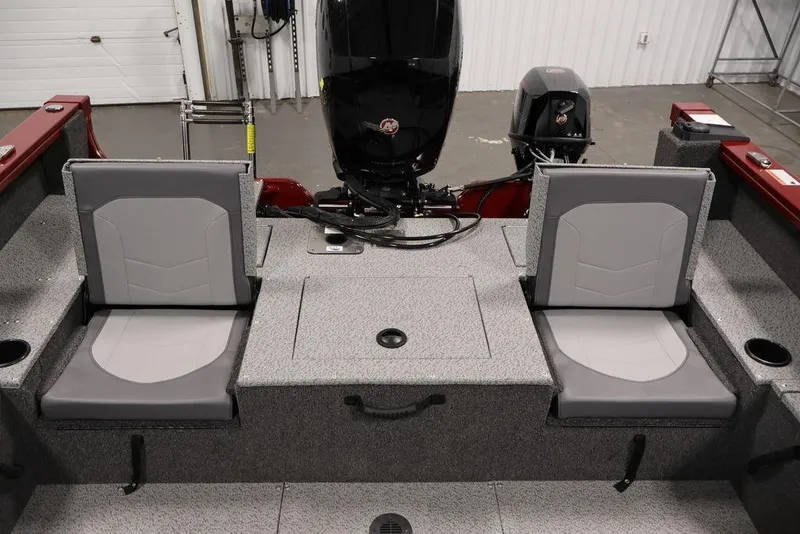 Slide: The Image of 2026 Lowe Fishing Machine 1875 interior with dual seats and motor, in a garage setting. - 30