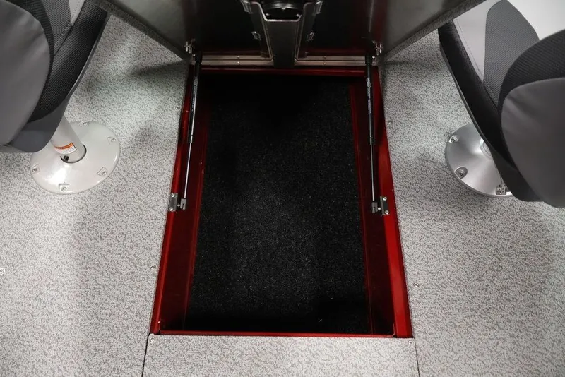 Slide: The Image of 2026 Lowe Fishing Machine 1875 boat interior with open storage compartment and seating. - 33