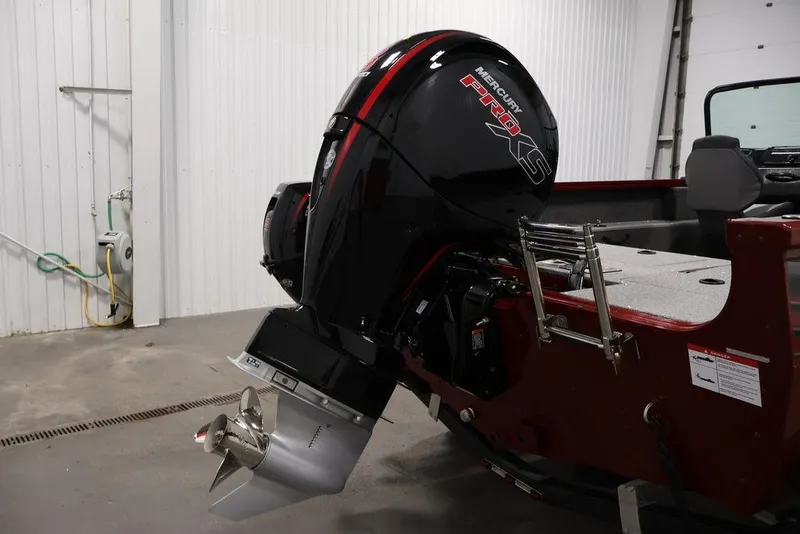 Slide: The Image of 2026 Lowe Fishing Machine 1875 with Mercury Pro XS outboard motor in a garage. - 35