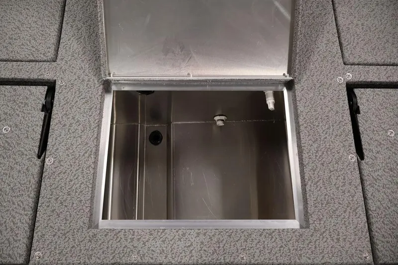 Slide: The Image of Open storage compartment in 2026 Lowe Fishing Machine 1875 boat, featuring durable interior design. - 36